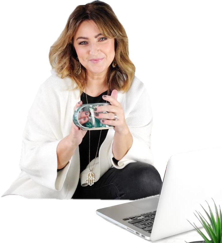 Melanie England, website designer and SEO specialist, with her laptop and a cup